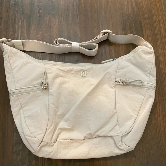 lululemon athletica Handbags - Lululemon slouchy sling bag 6l bone white color